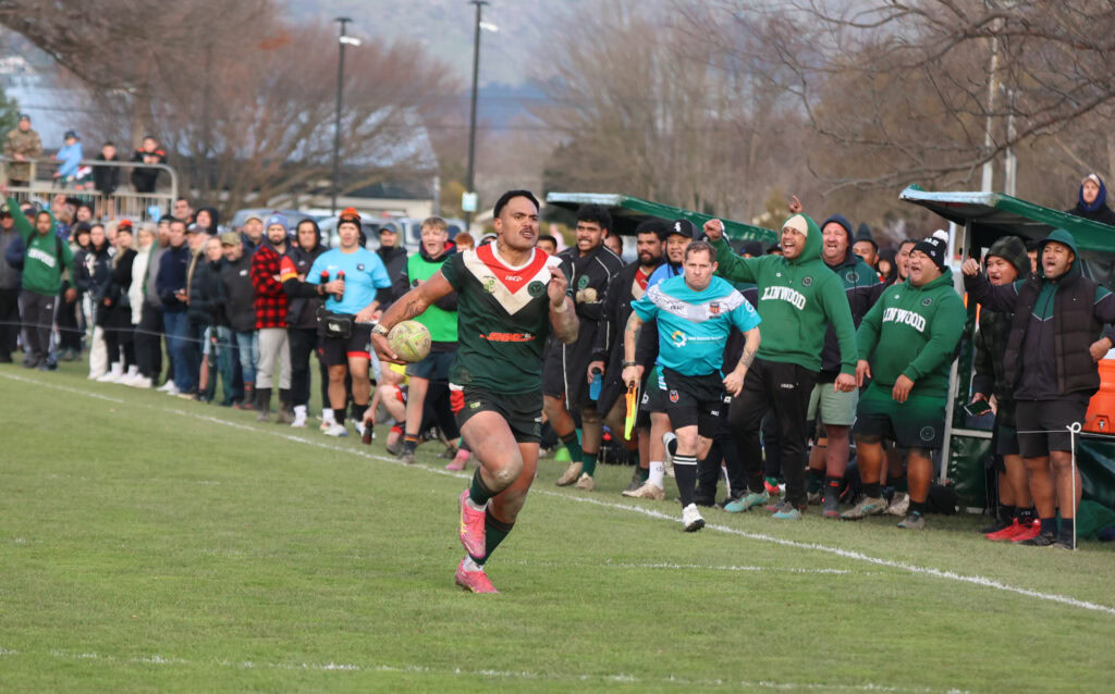 Danny Latu sprints down the touchline, supported by the crowd Danny Latu sprints down the touchline, supported by the crowd
